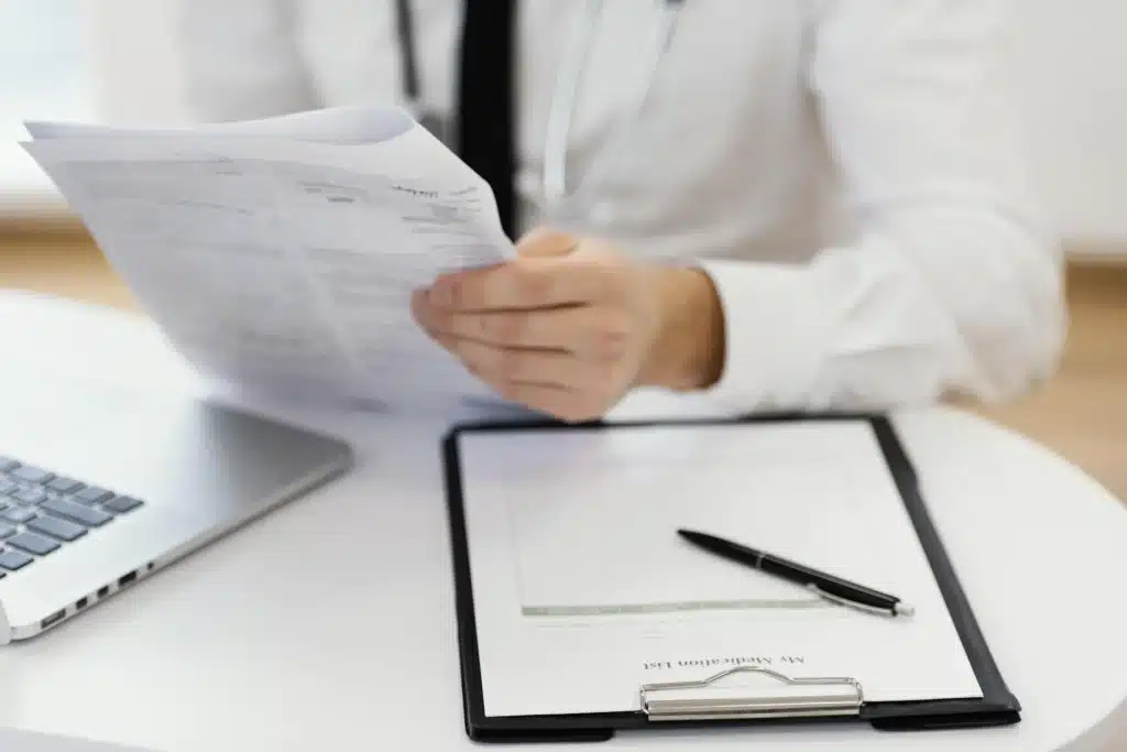 close up doctor holding medical records