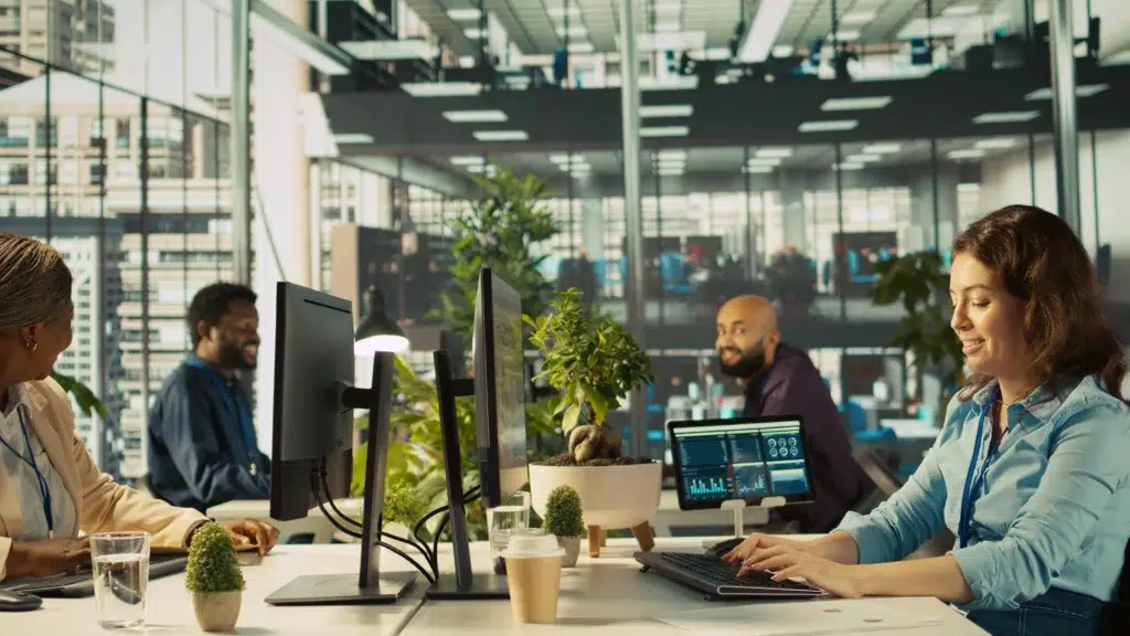 IT outsourcing team reviewing business performance graphs in an office