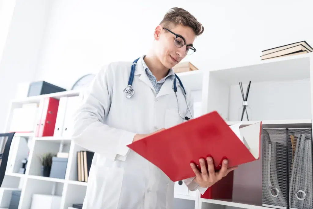 HCPCS Codes: The Complete Industry-Specific Reference Guide for Medical Billing 1 Medical coder reviewing paper records to assign correct HCPCS Level II codes.