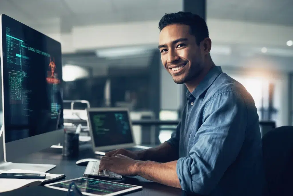 Remote software engineer focused on code at night in a dimly lit office