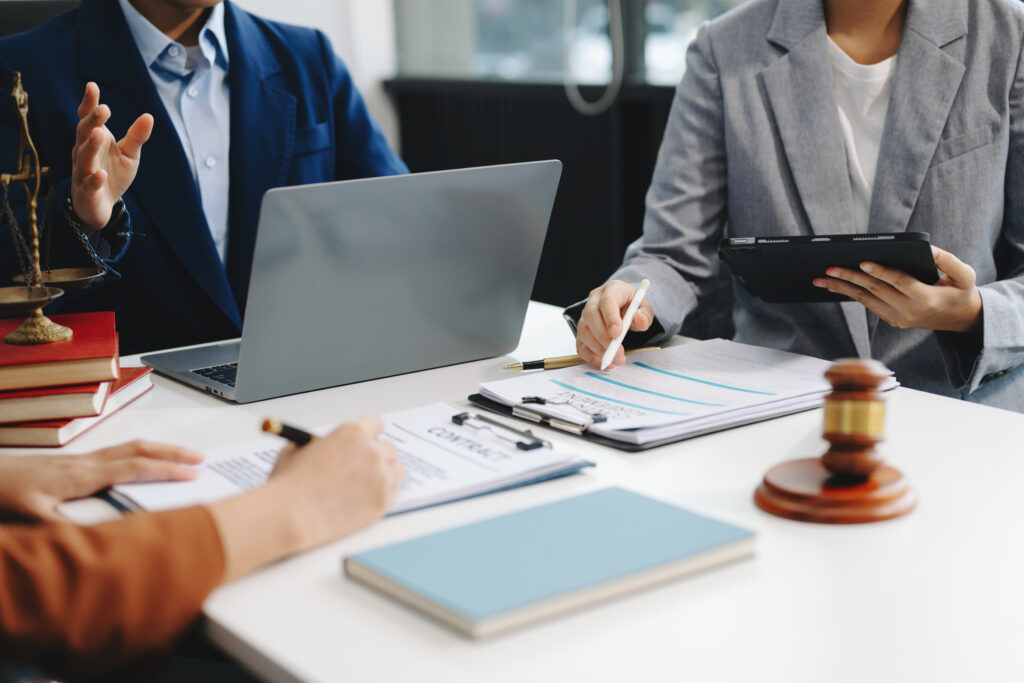 The Bilingual Intake Advantage: Why Law Firms Are Losing Spanish-Speaking Clients at the First Call 2 Legal team reviewing documents and contracts — core tasks managed by specialized legal process outsourcing companies to free up attorney time