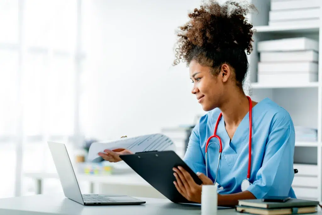 Medical Billing Automation in 2026: What Healthcare Leaders Need to Know Right Now 1 Young healthcare professional reviewing medical billing automation documentation at her desk