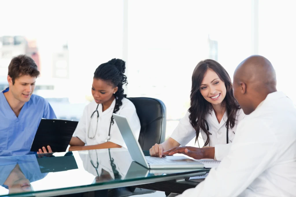 Diverse medical billing team discussing medical billing automation and RCM performance at modern office