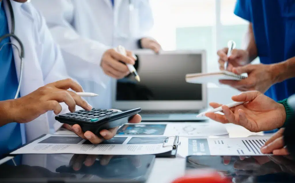 How to Outsource Medical Billing Services Without Disrupting Your Practice 2 Medical team reviewing billing documents — a common step before transitioning to outsourced medical billing