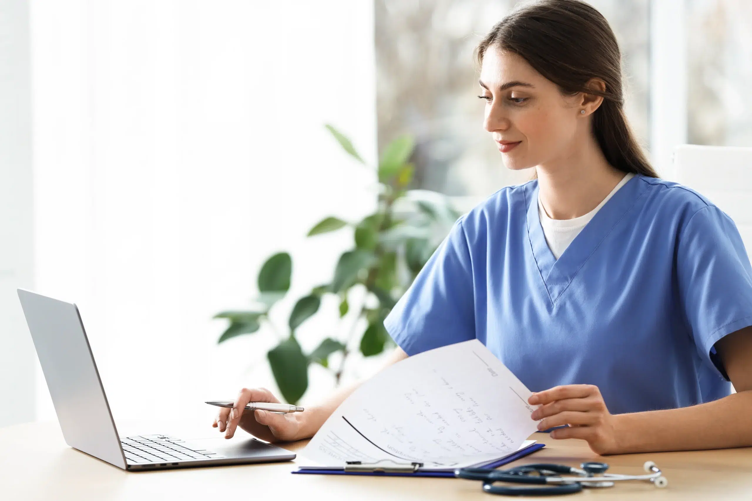 Healthcare professional managing billing paperwork — a task handled by outsource medical billing services partners