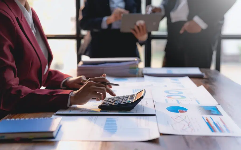 Professional finance team analyzing charts and graphs managed through accounting outsourcing services for CFOs