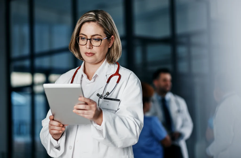 LATAM's Healthcare BPO Boom: The Numbers Behind the Fastest-Growing Outsourcing Market 1 Healthcare professional reviewing patient data, part of the operational shift driving healthcare business process outsourcing to LATAM