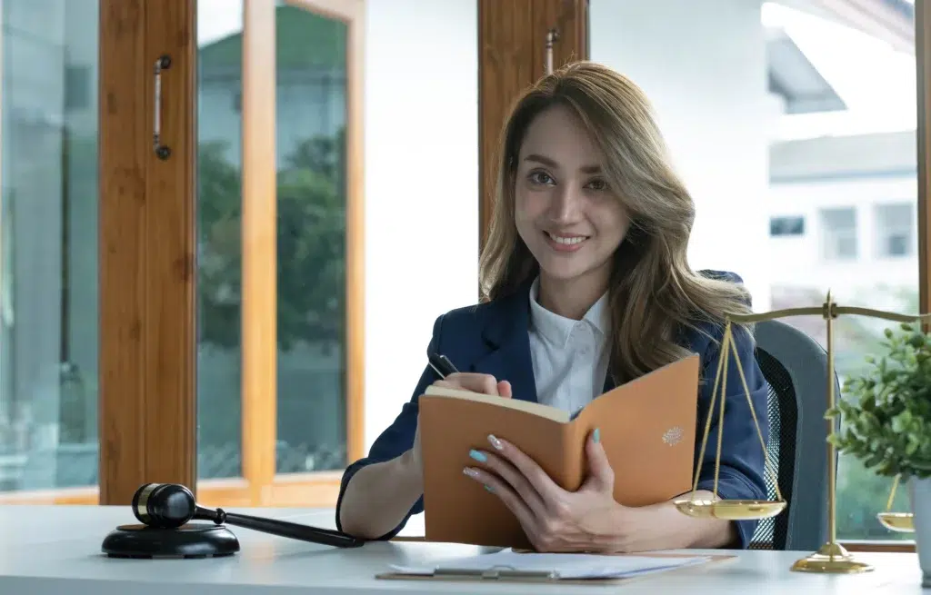 Smiling attorney working confidently in her office after deciding to hire a virtual legal assistant for her practice