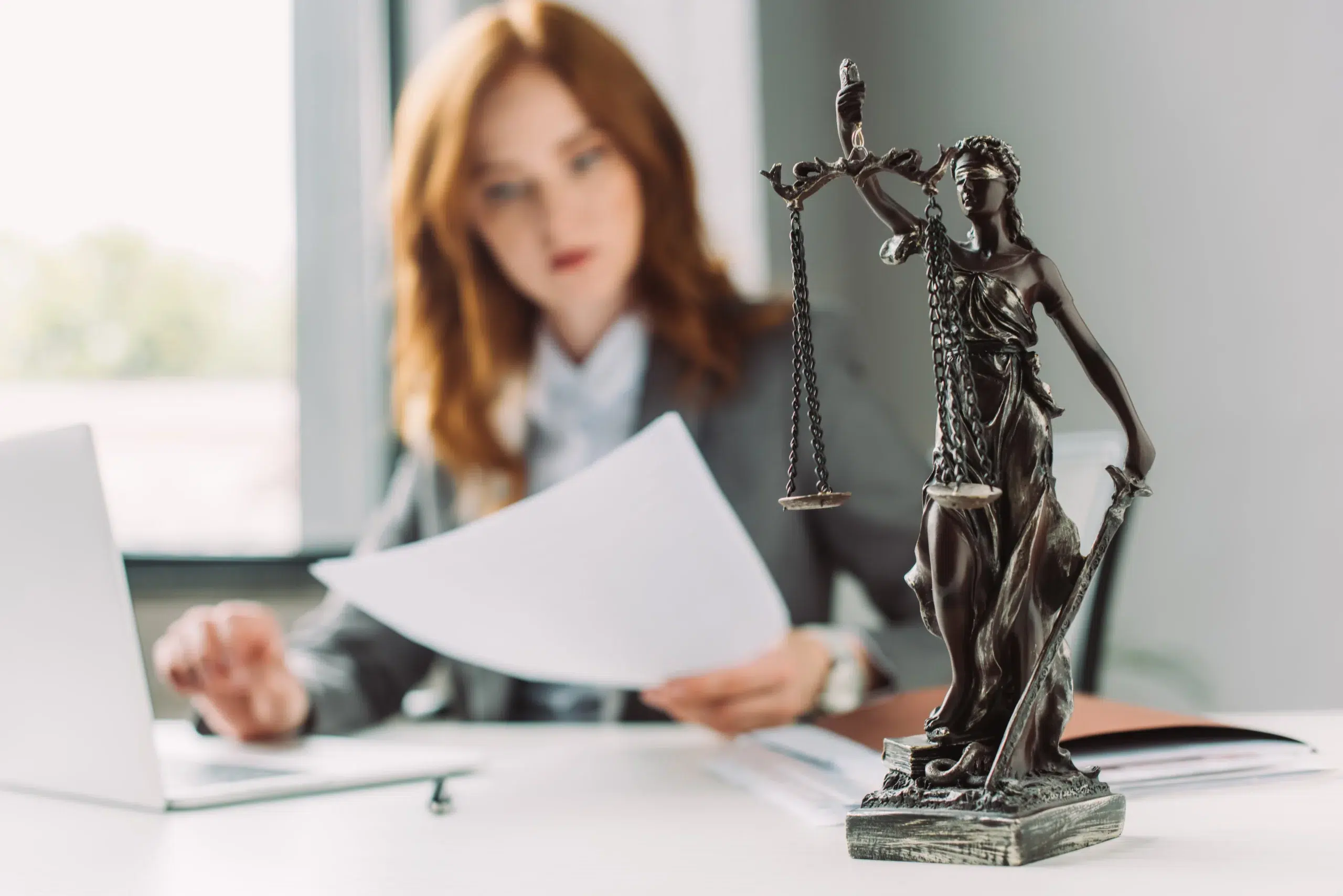 Law firm owner reviewing case files, the kind of work attorneys reclaim when they hire a virtual legal assistant