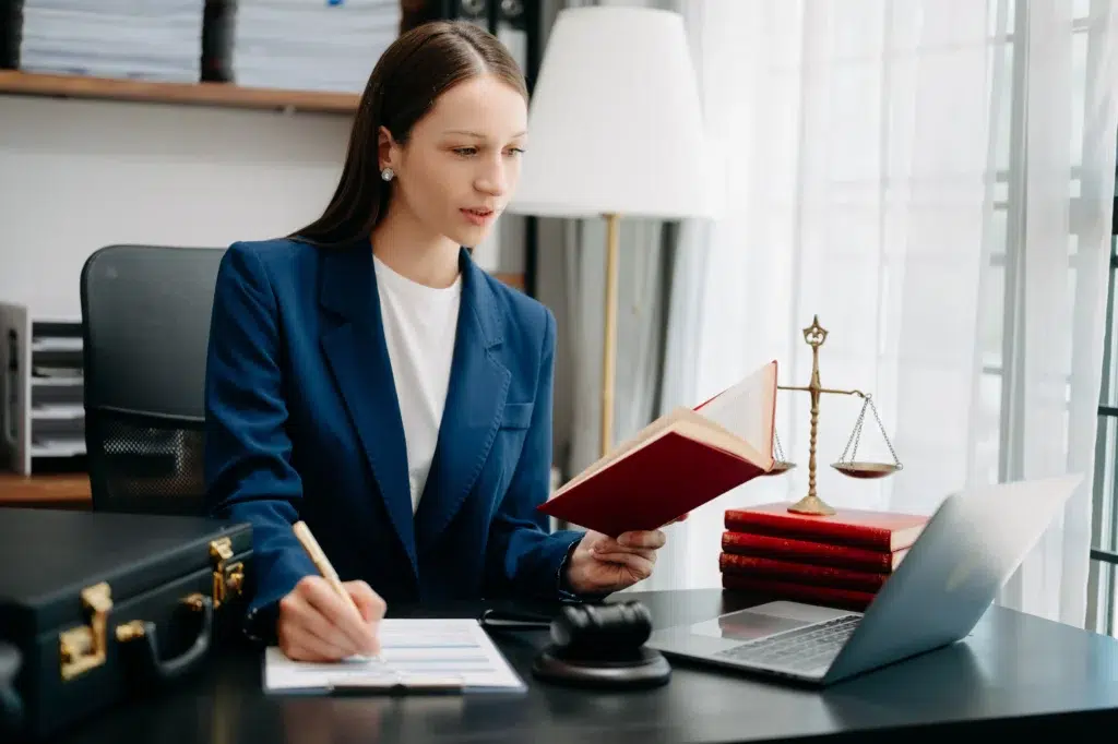 Law firm owner reviewing case files, the kind of work attorneys reclaim when they hire a virtual legal assistant