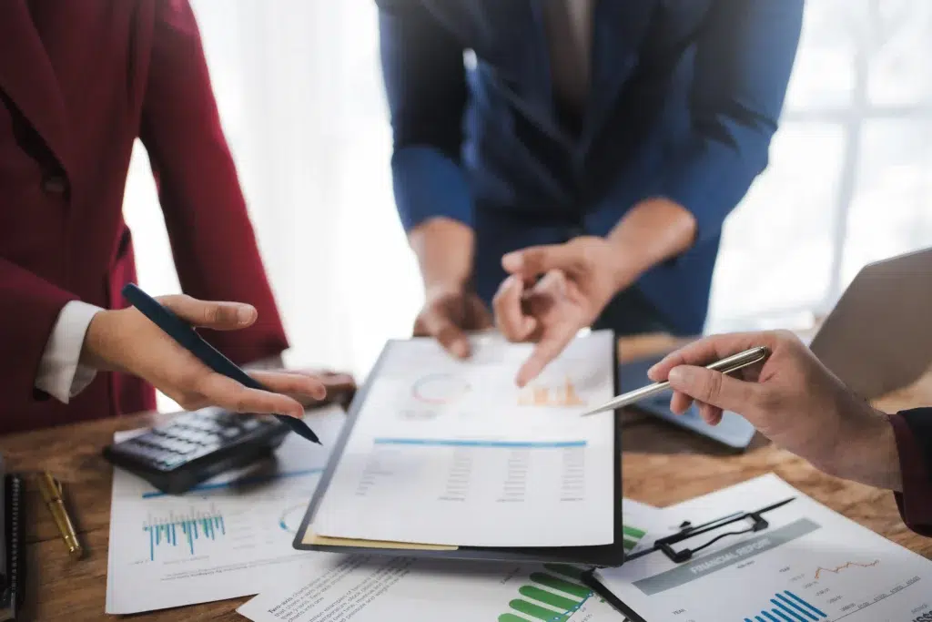 What CFOs Actually Outsource in 2026: A Finance and Accounting Decision Framework 3 Business team collaborating on financial documents supported by nearshore accounting outsourcing services