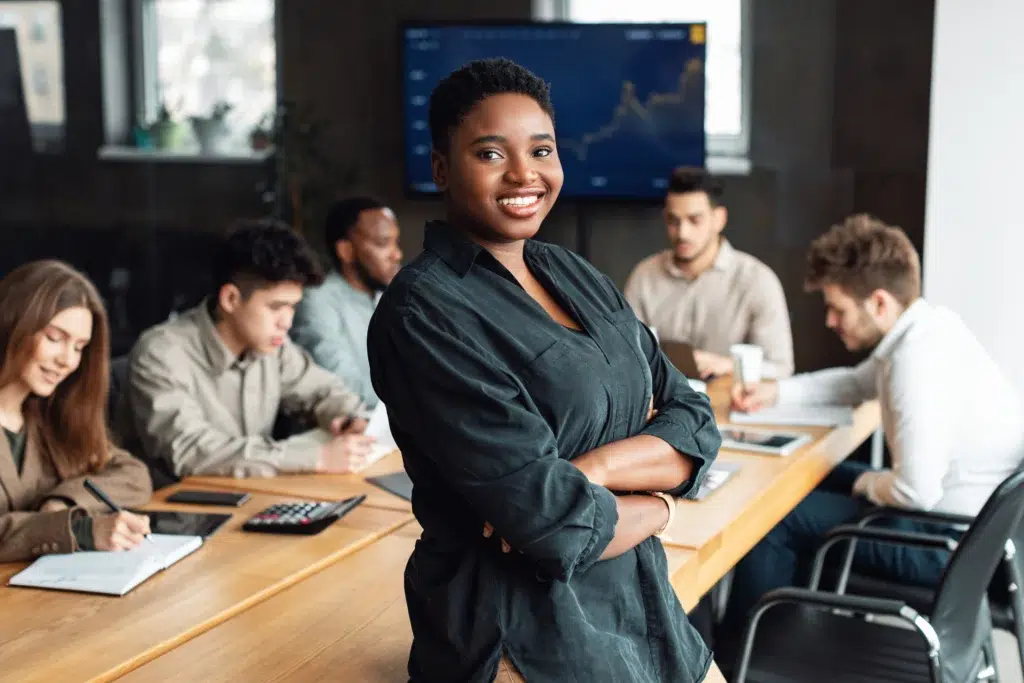 Payroll Outsourcing Services: What You Should Know Before Choosing a Partner 1 Business leader discussing payroll outsourcing services strategy with her finance team in a modern office