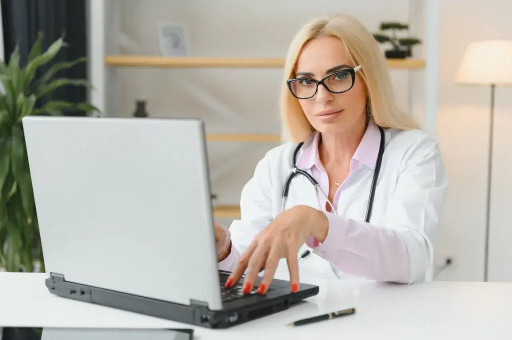 Eligibility and Prior Authorization: How to Protect Revenue in 2026 2 Doctor reviewing claims handled by prior authorization companies