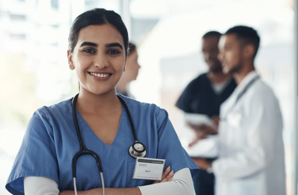 Smiling medical professional and her team, supporting accurate 99205 CPT code documentation and billing workflows in a healthcare practice