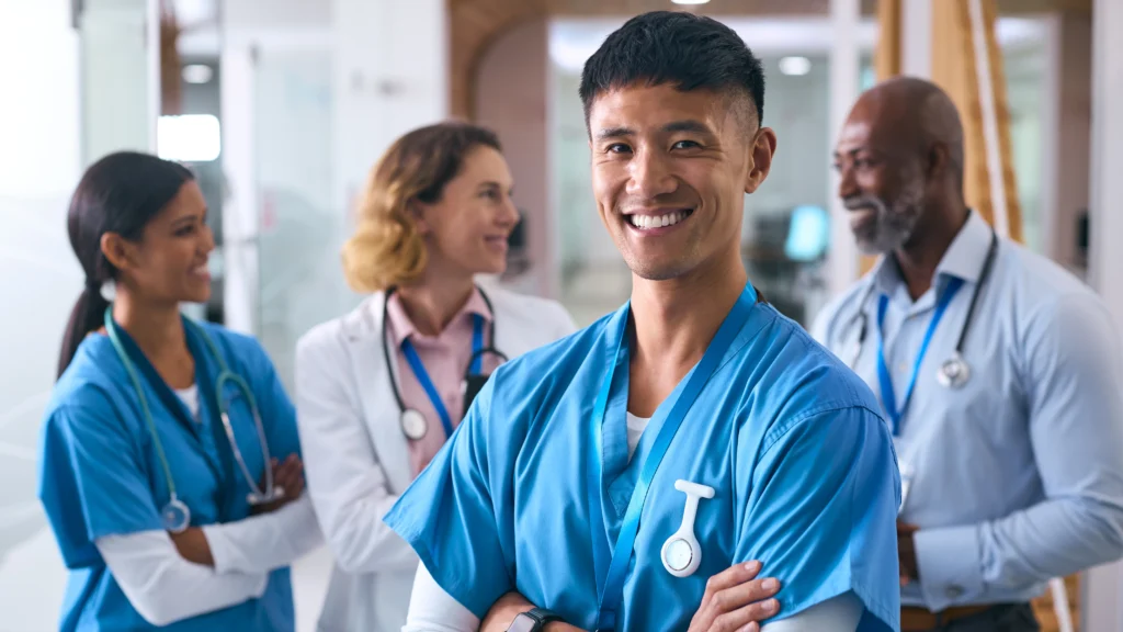 Why Health Systems Are Consolidating RCM Vendors Under One Healthcare Partner in 2026 3 Smiling multi-cultural medical team collaborating, reflecting how healthcare vendor management companies unify billing, coding, and prior authorization under one team