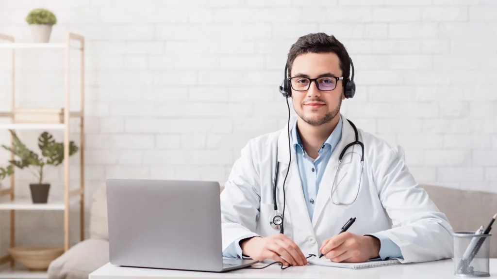 Doctor conducting an online consultation while documenting ongoing patient care to support G2211 CPT code billing