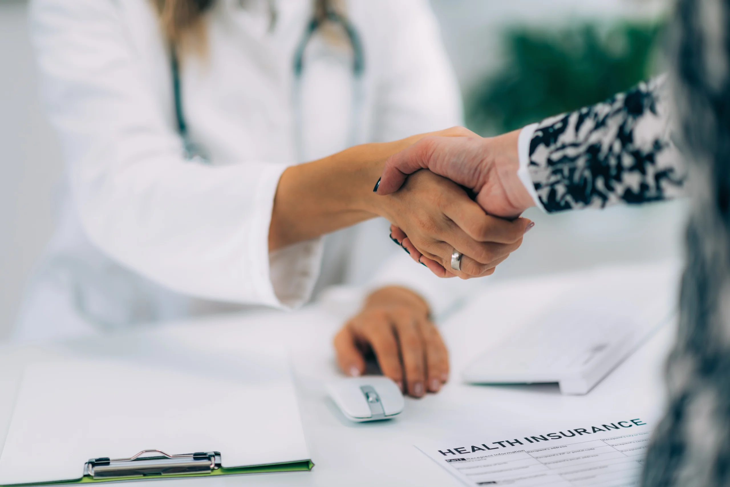 Physician and patient in a clinic supported by prior authorization outsourcing solutions