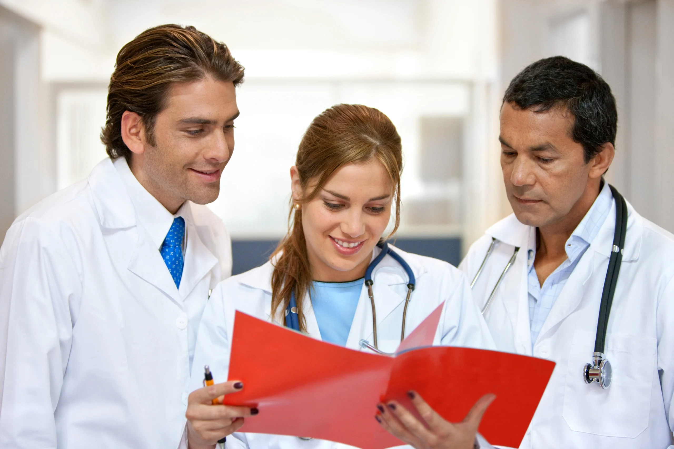 Doctors reviewing patient records after outsourcing medical billing for cost savings