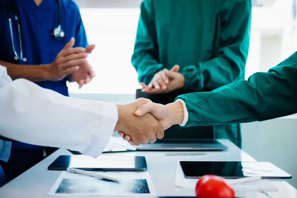 Looking to Outsource Prior Authorization Services? 3 Doctor and patient reviewing insurance authorization after outsourcing prior authorization services