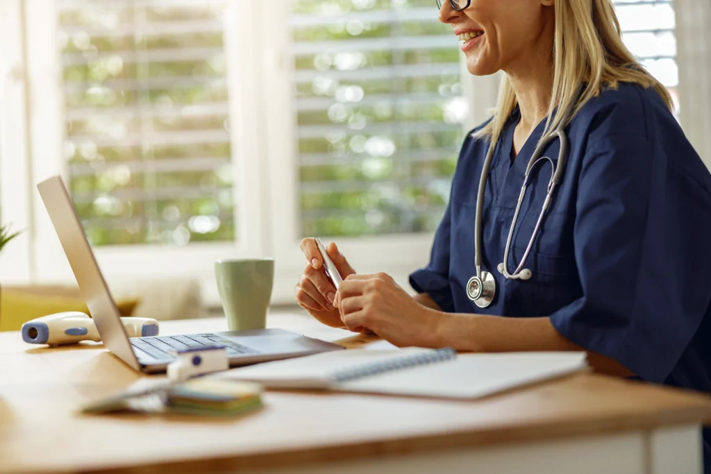 Doctor checking insurance eligibility verification paperwork at her desk