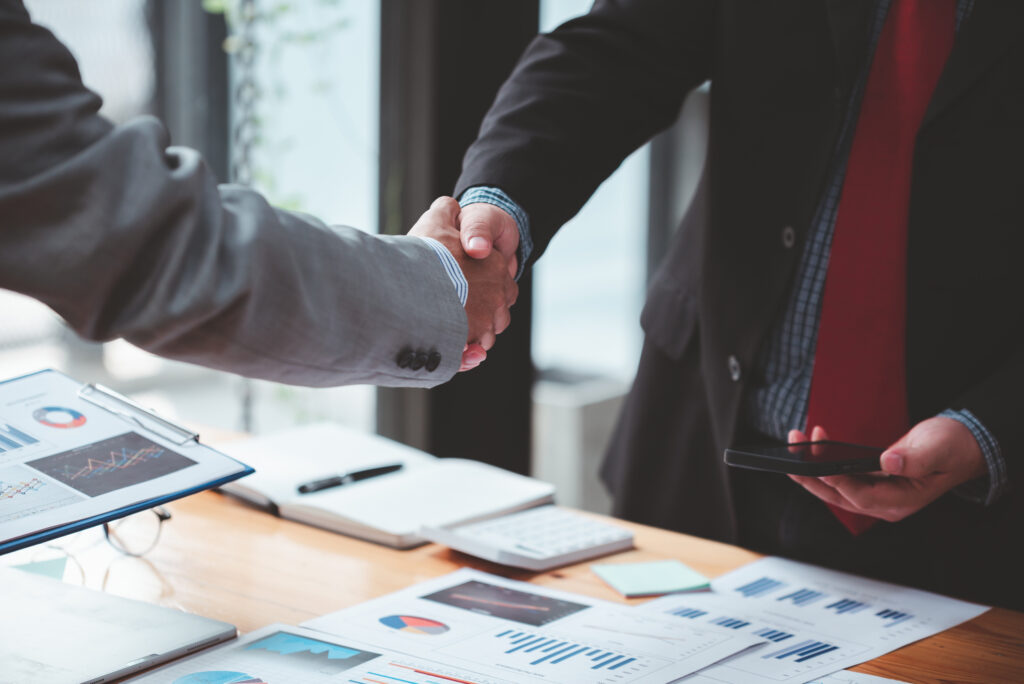 AI Is Changing Contract Management. Here's Why More Law Firms Are Expected to Outsource It. 3 Attorneys reviewing contract terms, the kind of work contract management outsourcing services can take off their plate