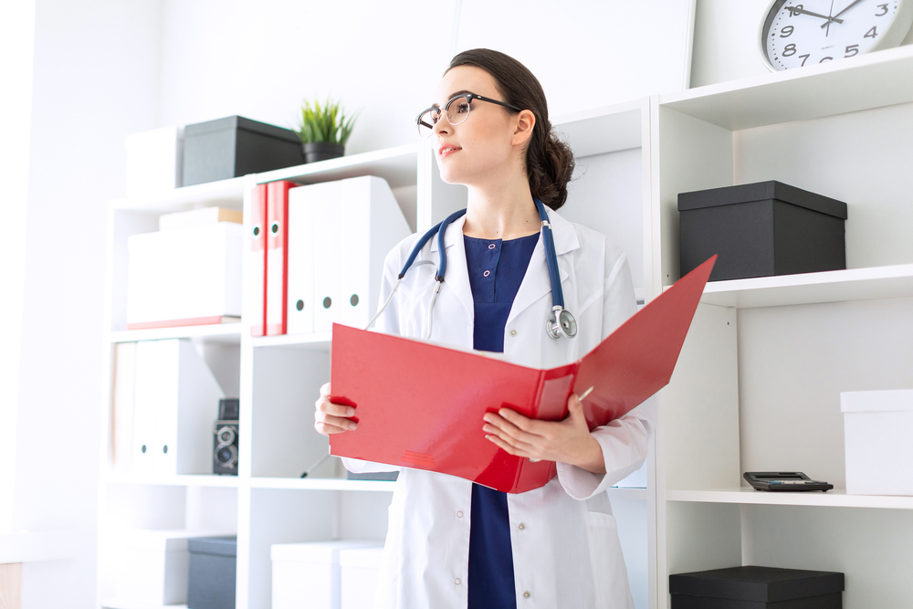 Healthcare staff member checking the schedule on a tablet, a task an outsource medical scheduling can handle